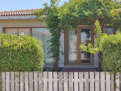 a house with a wooden fence in front of it at Villa Casablanca with private pool in Lozenets