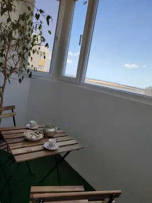 a table in a room with two windows at Sunrise home in Burgas City