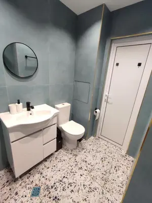 a bathroom with a toilet and a sink and a mirror at Sunrise home in Burgas City