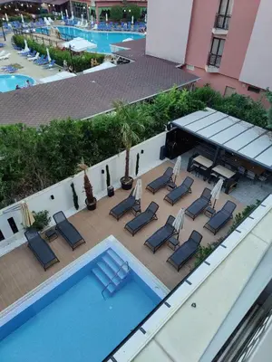 an overhead view of a swimming pool with lounge chairs at Sunny Bay Sweet Homes Lux Apartment in Sunny Beach
