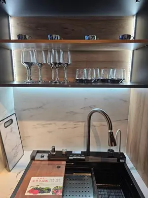 a kitchen with glasses on a shelf with a sink at Sunny Bay Sweet Homes Lux Apartment in Sunny Beach