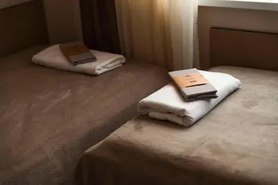 two folded towels sitting on top of a bed at Galata Relax in Varna City