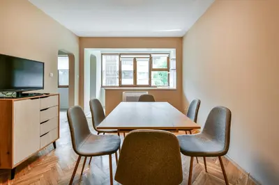 a dining room with a table and chairs and a television at Central location 2BR - 6 guests in Varna City