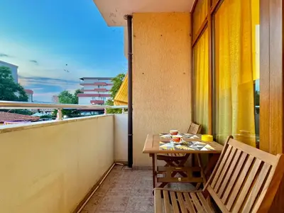 a balcony with a table and chairs on a balcony at Prime Location Studio Midia Beach in Sunny Beach