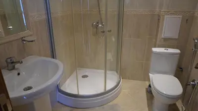 a bathroom with a shower and a toilet and a sink at Fortuna Cape B46 - Фортуна Кейп В46 in Byala