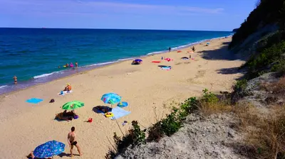 a group of people on a beach with umbrellas at Fortuna Cape B46 - Фортуна Кейп В46 in Byala