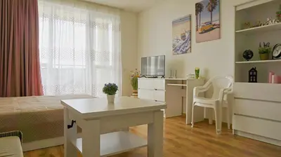 a bedroom with a bed and a table and a desk at Fortuna Cape B46 - Фортуна Кейп В46 in Byala