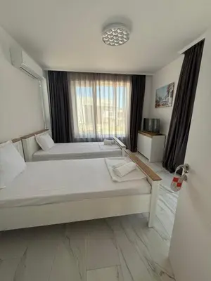 a bedroom with two beds and a window at Aurum Villas Smokinya Beach 3 in Sozopol
