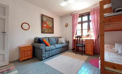a living room with a couch and a bunk bed at Bulgarian country house near the sea in Banya