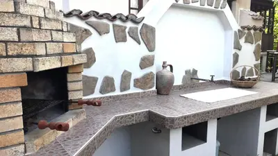 a stone counter in front of a brick fireplace at Bulgarian country house near the sea in Banya