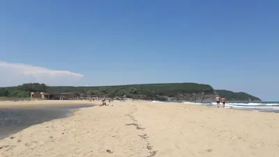 a group of people walking on the beach at Bulgarian country house near the sea in Banya