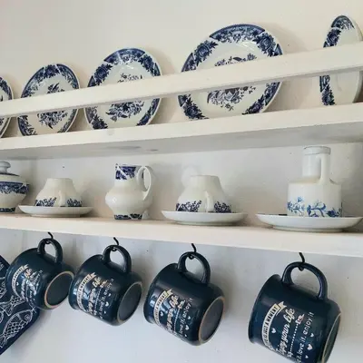 a shelf filled with blue and white china at Bulgarian country house near the sea in Banya