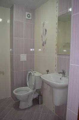 a bathroom with a toilet and a sink at Guest House Georgievi in Primorsko