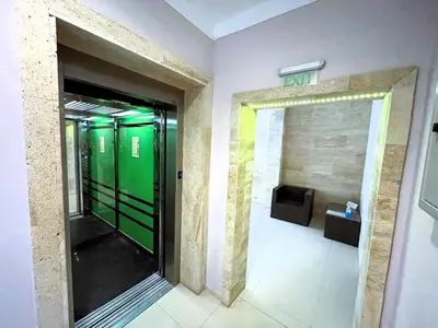 a hallway with green doors in a building at Apart-Hotel Panorama Sea LUX in Primorsko