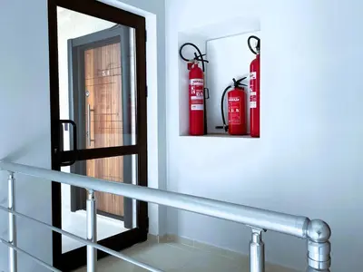 a mirror and two fire hydrants on a wall at Apart-Hotel Panorama Sea LUX in Primorsko