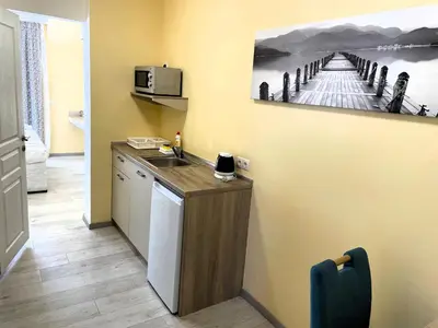 a kitchen with a sink and a microwave at Apart-Hotel Panorama Sea LUX in Primorsko