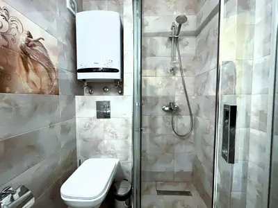 a bathroom with a shower with a toilet and a sink at Apart-Hotel Panorama Sea LUX in Primorsko