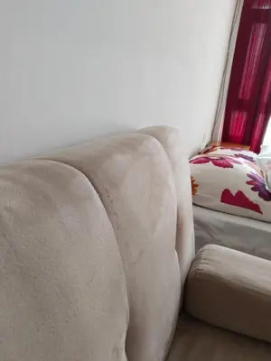 a couch sitting in a living room next to a chair at Партерни студия без обособен балкон ул Т Светослав 5 и ул България in Pomorie