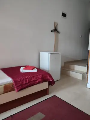 a bedroom with a bed with a red blanket at Партерни студия без обособен балкон ул Т Светослав 5 и ул България in Pomorie