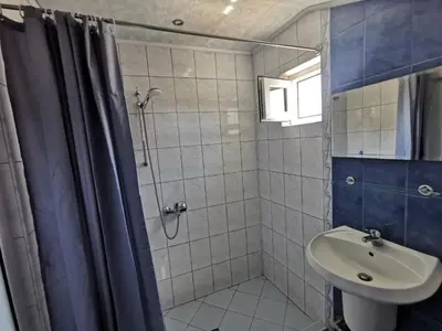 a bathroom with a shower and a sink at Апартамент Хармония ТОП Център в Стария Град in Pomorie