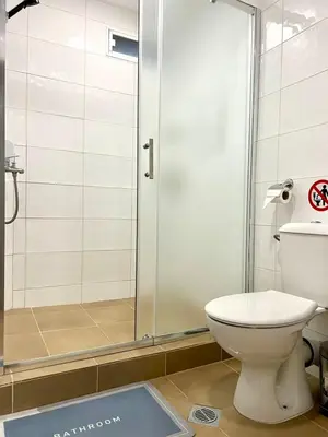 a bathroom with a toilet and a shower at Centrino in Burgas City