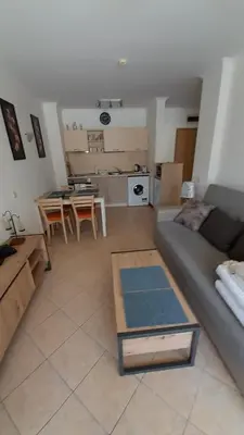 a living room with a couch and a table at 2 Room Apartment Royal Sun E24 with Poolview and big Balcony in Sunny Beach