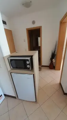 a microwave on top of a counter in a room at 2 Room Apartment Royal Sun E24 with Poolview and big Balcony in Sunny Beach