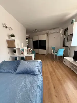 a bedroom with a bed and a dining room at Sarafovo Sea and Airport Stay in Burgas City