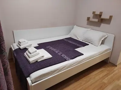 a white bed with towels on top of it at Blue Beach Apartments - Melia in Ravda