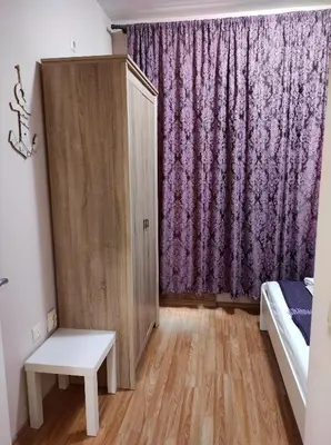 a bedroom with a bed and a purple curtain at Blue Beach Apartments - Melia in Ravda