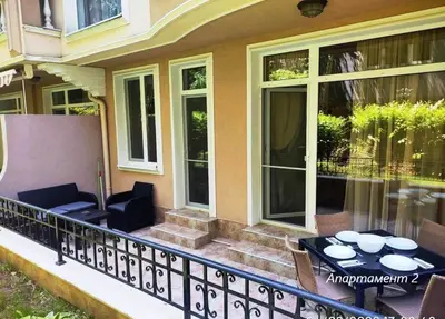 a balcony with a table and chairs on a house at Blue Beach Apartments - Melia in Ravda