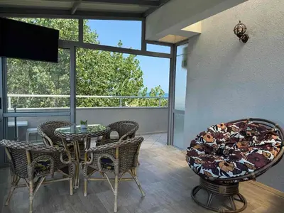 a dining room with a table and chairs on a balcony at TROPIC BEACH apart in Sunny Beach