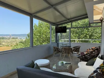a living room with a couch and chairs and windows at TROPIC BEACH apart in Sunny Beach