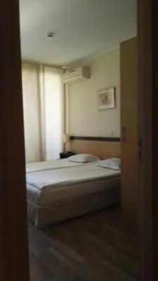a bedroom with two beds in a room with a window at Panoramic sea view at the beach in Obzor