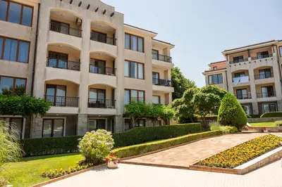an apartment building with a garden in front of it at Paradise View Guest Apartment in Sozopol