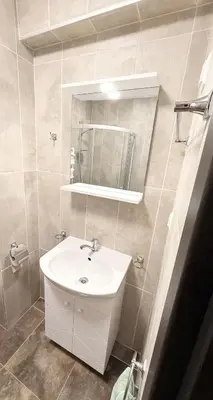 a bathroom with a sink and a mirror at Stylish studio near harbor and luxury beach in Sveti Vlas