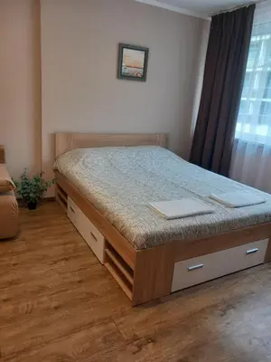 a bedroom with a bed in a room with a window at Силви Съни Бийч Плаза in Sunny Beach