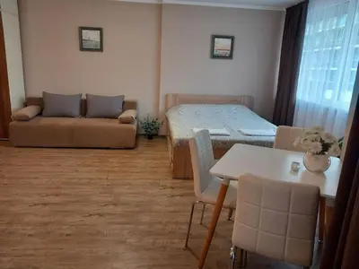 a room with a bed and a couch and a table at Силви Съни Бийч Плаза in Sunny Beach