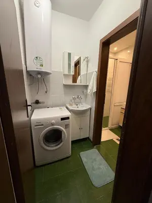 a bathroom with a washing machine and a sink at Pomorie S&T Home in Pomorie