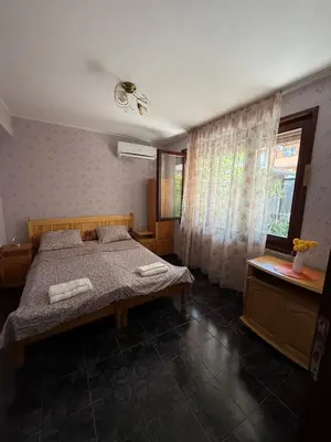 a bedroom with a bed and a window at Pomorie S&T Home in Pomorie