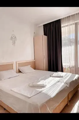 a bedroom with a large white bed with a window at Royal Sun - Vaio - 1BR Apt with Balcony - Pool View in Sunny Beach