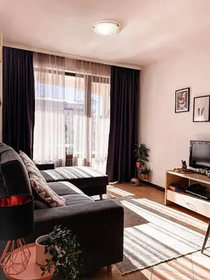a living room with a couch and a television at Royal Sun - Vaio - 1BR Apt with Balcony - Pool View in Sunny Beach