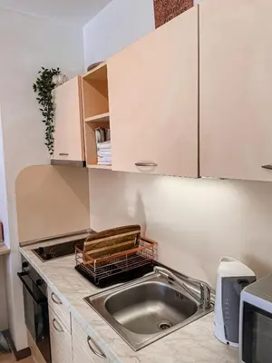 a kitchen with a sink and a microwave at Royal Sun - Vaio - 1BR Apt with Balcony - Pool View in Sunny Beach