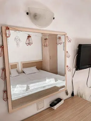 a small bedroom with a bed in a mirror at Royal Sun - Vaio - 1BR Apt with Balcony - Pool View in Sunny Beach
