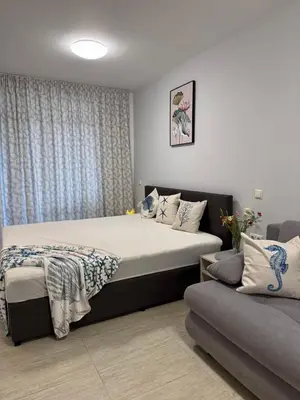 a bedroom with a large bed and a couch at Dream Life Sozopol in Sozopol