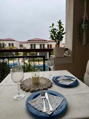 a table with two plates and two wine glasses at Dream Life Sozopol in Sozopol