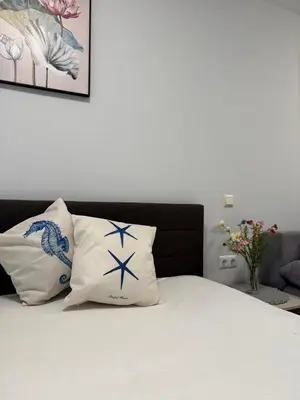 a bedroom with a bed with two pillows at Dream Life Sozopol in Sozopol