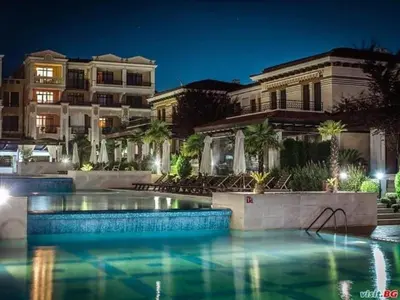 a swimming pool in front of a building at night at Dream Life Sozopol in Sozopol