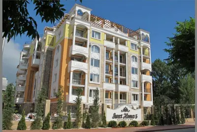 an apartment building with a yellow and white facade at Apart Sweet Homes 5 - Apartments for guests in Sunny Beach