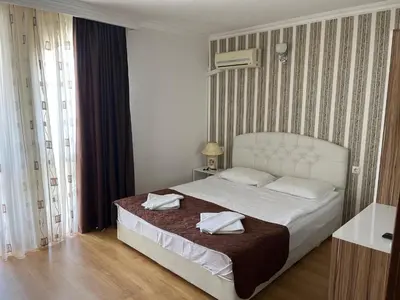 a bedroom with a bed with two towels on it at Apart Sweet Homes 5 - Apartments for guests in Sunny Beach